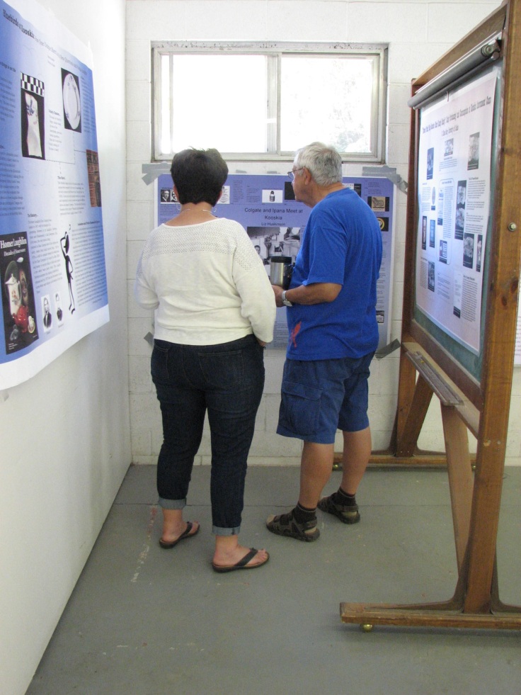 Visitors peruse posters analyzing different aspects of the 2010 archaeological assemblage made by students in Dr. Camp's 2010 and 2013 Historic Artifact Analysis course